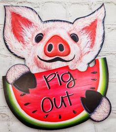 a pig out sign hanging on the side of a building with a piece of watermelon in it's mouth