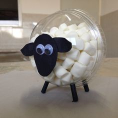 a bowl filled with marshmallows sitting on top of a table