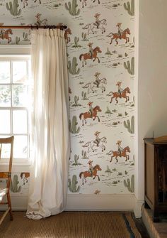 a room with a window and wallpaper that has horses on it, along with a chair