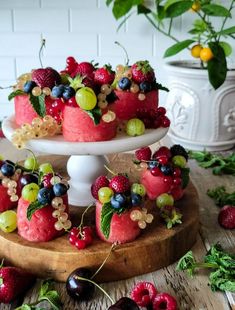 there is a cake with fruit on the top and berries on the bottom, along with other desserts