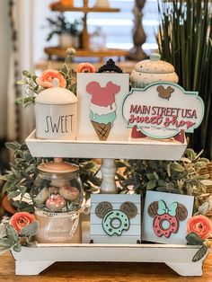 three tiered trays with magnets on top of each other and flowers in the background