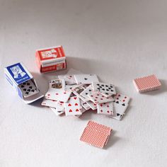 several playing cards are scattered on a white surface