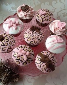 cupcakes with pink frosting and chocolate decorations