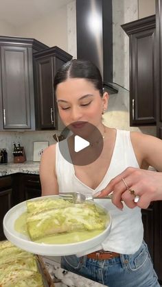 a woman holding a plate with food on it