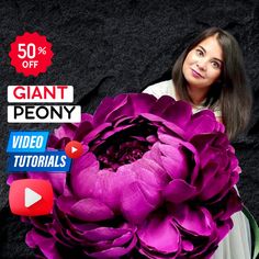 a woman holding a large purple flower with the words giant peony written below it