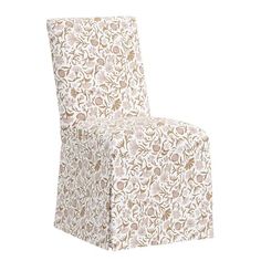 a white and brown chair with a flower pattern on the seat cover that has been folded over