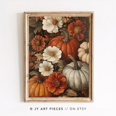 a painting with flowers and pumpkins hanging on the wall