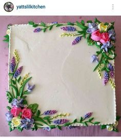 a cake decorated with flowers on top of a table