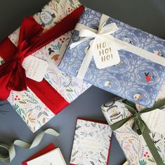 several wrapped gift boxes with bows and tags on them, all decorated in christmas themed paper