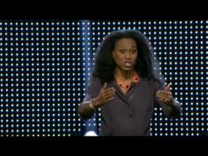 a woman standing on top of a stage with her hands out in front of her