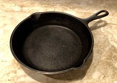 an empty cast iron skillet sitting on a counter