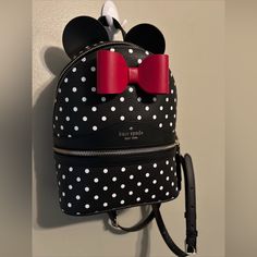 This Kate Spade New York Backpack Features A Charming Minnie Mouse Design, Perfect For Any Disney Fan. The Bag Is Made Of Durable Leather And Has A Zip-Around Closure With Adjustable Straps For A Comfortable Fit. It Has A Medium Size With A Width Of 8 Inches, Height Of 13 Inches, And Depth Of 4.75 Inches. The Bag Includes Inner And Outer Pockets For Ample Storage, As Well As A Lined Interior. The Hardware Is Silver In Color, And The Bag Has A Black Exterior With A Polka Dot Pattern. This Limited Kate Spade Black Backpack With Detachable Strap, Kate Spade Leather Backpack For On-the-go, Disney Kate Spade Backpack, Kate Spade Leather Backpack, Kate Spade Leather Backpack With Detachable Strap For On-the-go, Casual Kate Spade Backpack For On-the-go, Kate Spade Backpack Purse, Disney Handbags Kate Spade New York, Kate Spade Backpack