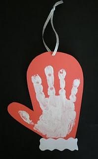 a handprinted ornament is hanging on a black background with an orange tag