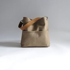 The perfect mid-size hobo bag to hold everything you need.  This canvas tote has lots of pockets to stay organized and is compact yet spacious with a casual, slightly slouchy shape that is easy to carry as a crossbody bag or shoulder bag.  This listing is for the MEDIUM size bag in Camel color Canvas. DETAILS: Approximately 10.5in H x 11in W x 2.5in D. Durable woven canvas exterior in Khaki canvas with a slightly faded finish. Two exterior front pockets. Magnetic snap closure at top center. Full Canvas Hobo Bag, Hobo Tote Bag, Summer Purses, Urban Chic Fashion, Fall Handbags, Canvas Crossbody Bag, Everyday Bag, Medium Bags, Hobo Bag