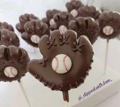 chocolate baseball cake pops with white and brown frosting on top are ready to be eaten