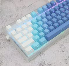 a blue and white keyboard sitting on top of a table