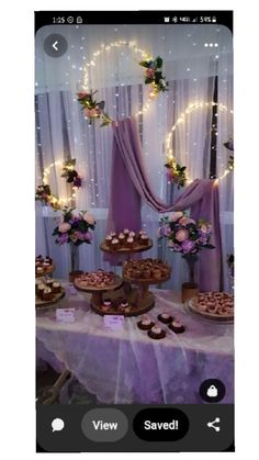 a table topped with cakes and cupcakes on top of a purple table cloth