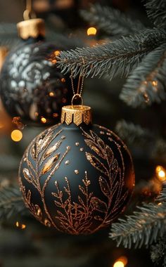 a black and gold christmas ornament hanging from a tree