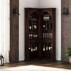 a tall wooden cabinet with wine bottles on it's shelves in a living room