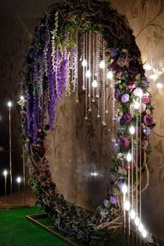 a circular mirror decorated with flowers and lights