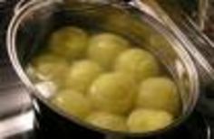 a bucket filled with yellow apples sitting on top of a counter