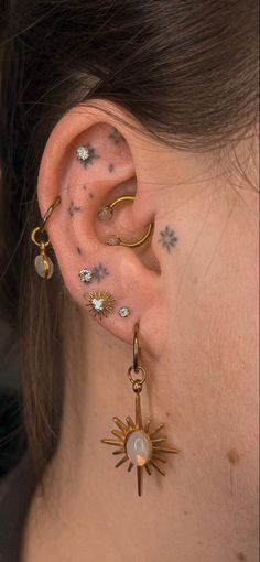 a close up of a person with ear piercings