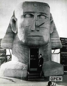 a man standing in front of a giant statue