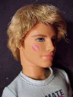 a doll with blonde hair and pink lipstick painted on it's face is shown