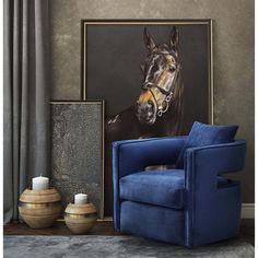 a blue chair sitting in front of a painting