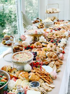 a long table filled with lots of food and desserts on top of each other