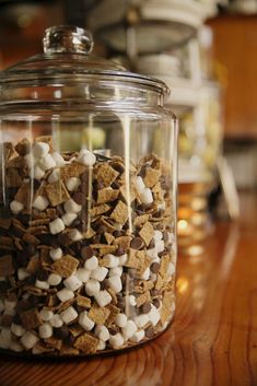 a glass jar filled with marshmallows and chocolate chips