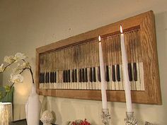 a wall with candles, vases and other items on it in front of a piano