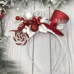 a red and white hat with snowflakes on it, surrounded by christmas decorations