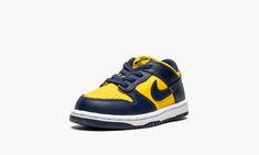 The Nike Dunk Low TD “Michigan” is the toddler version of the college basketball inspired colorway of the classic basketball and lifestyle shoe.  Originally created by Nike for the Michigan Wolverines basketball team, the “Michigan” Dunk was part of the influential “Be True to Your School” collection from 1985.  The Varsity Maize and Midnight Navy colorway was brought back in September 2020 on the model’s alternate high-top design.  Here, on the low-top, the colorway follows the same style caden Michigan Wolverines Basketball, Yellow Nikes, School Collection, Basketball Team, Stadium Goods, Maize, Michigan Wolverines, Nike Kids