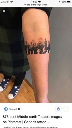 a person with a forest tattoo on their arm