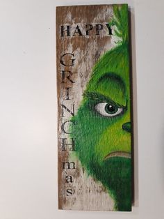 a wooden sign with the grin face painted on it