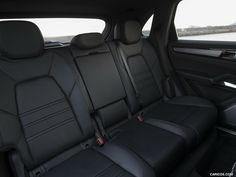 the interior of a car with black leather seats and water in the back ground behind it