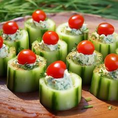 cucumbers with tomatoes and dill are arranged on a wooden platter, ready to be served