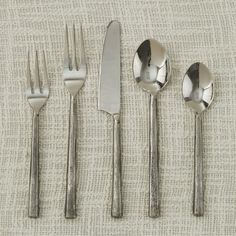 five forks, two knives and three spoons on a table