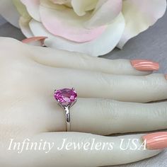 "The ring pictured is a lab created pink sapphire #6448 -Approximate total carat weight: approx. 3.00ctw diamond equivalent -Center Stone Size: 10x8mm - approx. 3.00ct diamond equivalent -Center Stone Shape: oval -Gem Type: lab created sapphire -Stone Clarity: VS2 -Stone Color: Medium Pink -Moh's Scale: 9 hardness -Metal Type and Purity: 14k white gold -Setting: 4 prong open U head -Stock Ring Size: 6 -Country of Manufacturing: USA (Michigan) For customization please contact us. If you have any Classic Pink Ruby Ring With Accent Stones, Pink Ruby Gemstone Ring For Anniversary, Pink Oval Gemstone Birthstone Ring, Pink Heart Cut Gemstone Jewelry, Pink Sapphire Ring Birthstone Fine Jewelry, Pink Round Cut Ruby Ring In Fine Jewelry Style, Pink Round Cut Birthstone Ring With Gemstone, Pink Round Cut Birthstone Ring With Center Stone, Pink Birthstone Ring With Round Cut Center Stone