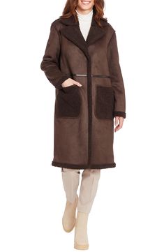 Ultrasoft faux-shearling trim outlines the cuffs, patch pockets and notch collar of this reversible faux-leather coat designed with a water-resistant finish. 45" length Hidden-button placket Notched collar Front patch pockets Water resistant Lined 100% polyester with 100% polyester faux-shearling trim Machine wash, line dry Imported Brown Outerwear With Faux Fur Trim For Work, Shearling Outerwear With Pockets For Work, Sheepskin Outerwear With Pockets For Work, Brown Winter Outerwear With Faux Front Pockets, Brown Fur Coat With Faux Fur Lining For Work, Leather Fur Coat With Faux Fur Trim For Work, Brown Fur Coat With Pockets For Work, Faux Leather Coat, Brown Fits