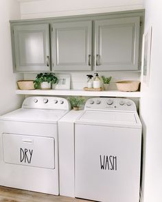 a white washer and dryer sitting in a kitchen next to eachother