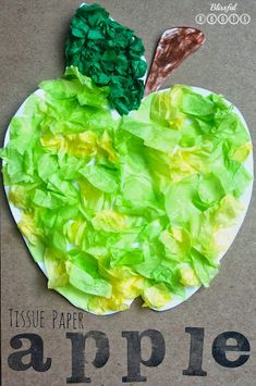 an apple made out of green leafy paper on top of a cardboard box with the words tissue paper apples