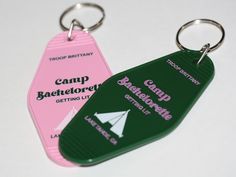 two green and pink tags with white arrows on them, one is for camp bachelors