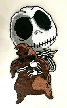 a cross stitch skeleton holding a teddy bear