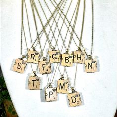 the necklaces are made with scrabble tiles and letters that spell out something