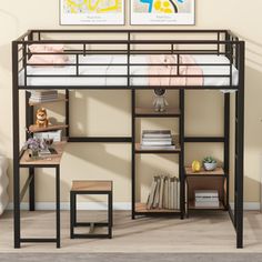 a loft bed with a desk underneath it in a room that has two pictures on the wall