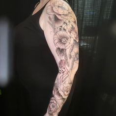 a woman's arm with flowers on it