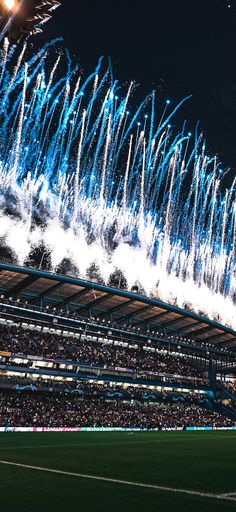 fireworks are lit up in the sky above a stadium