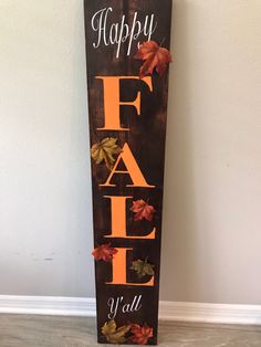 a wooden sign that says happy fall y'all with leaves on the front and bottom